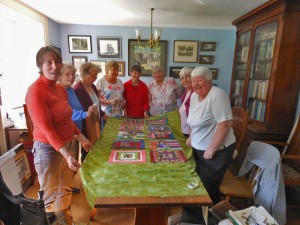 A photo of Lady members Assembling the squares for the quilt
